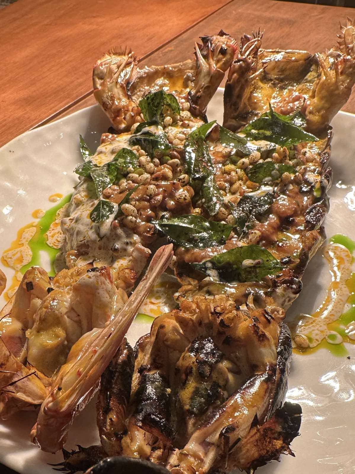Char-grilled mantis with spiced ‘champorado’ — like buro, fermented red rice, crab bisque, and curry leaves.