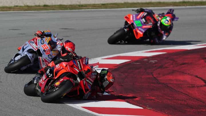 Ducati Italian rider Francesco Bagnaia rides ahead of Ducati Spanish rider Marc Marquez and Ducati Italian rider Franco Morbidelli during the Moto GP qualifying session for the Solidarity Grand Prix of Barcelona at the Circuit de Catalunya on 16 November, 2024 in Montmelo on the outskirts of Barcelona.