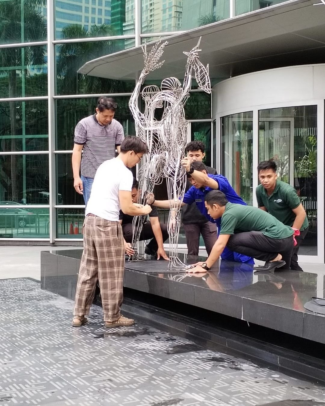 The team installs the sculptures.