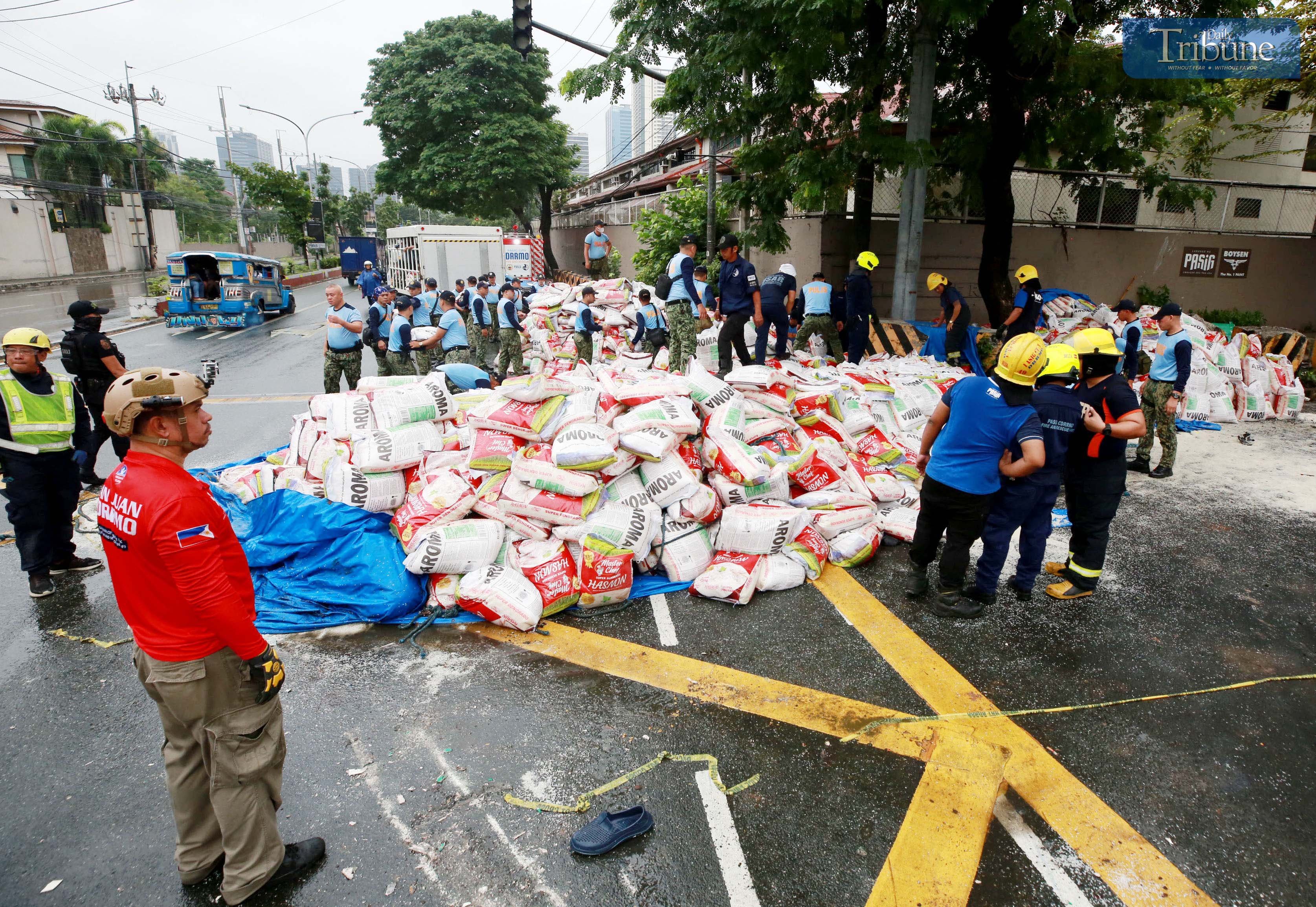 PNP and MMDA clear scattered rice after truck-motorcycle collision