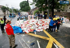 PNP and MMDA clear scattered rice after truck-motorcycle collision