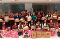 Maxine Esteban and Milka Romero (middle) put smile to the faces of the young athletes after donating running shoes, study lamps and biscuits to the Olongapo Junior Tracksters over the weekend.