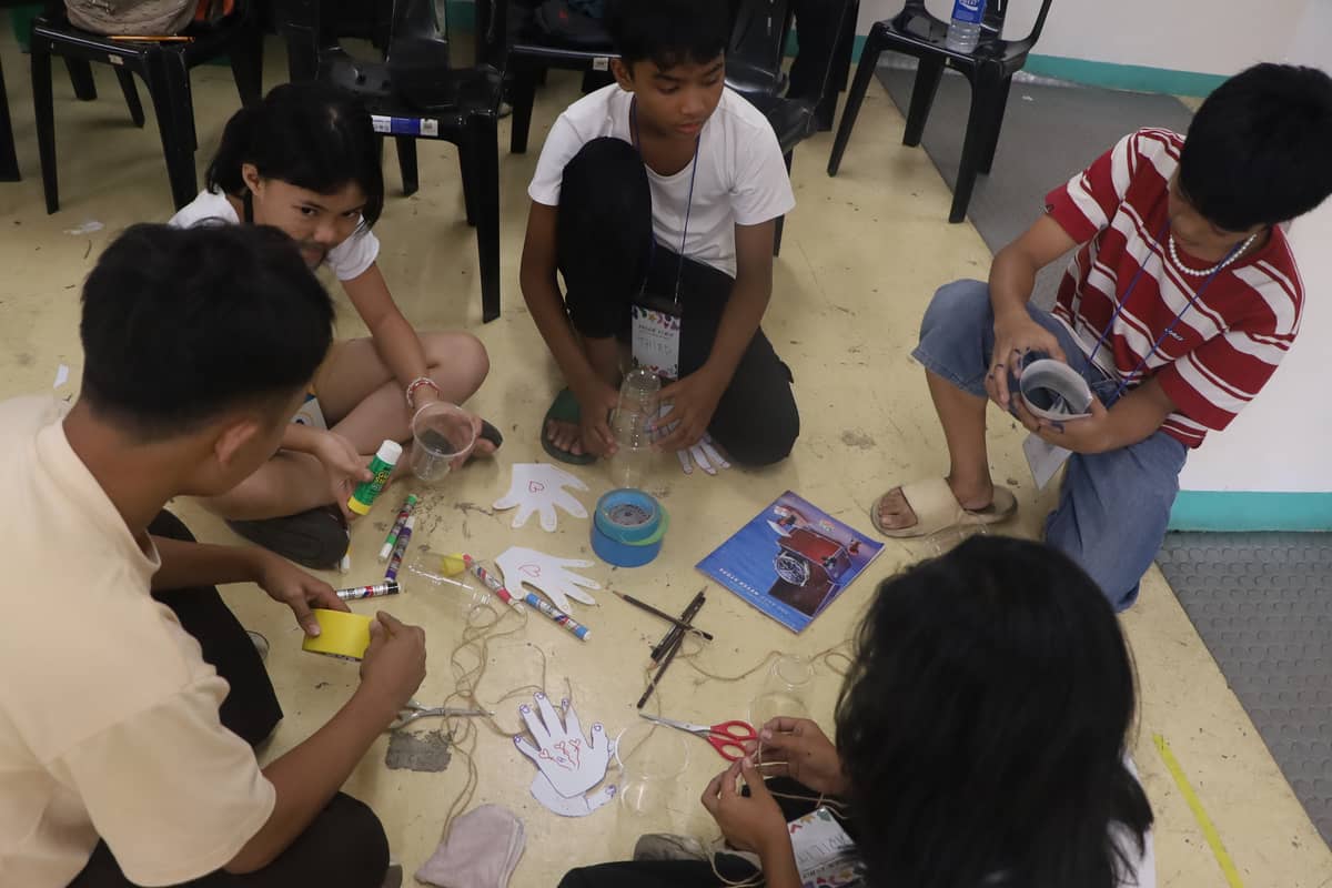 Young people of Tondo engaged in a workshop activity.