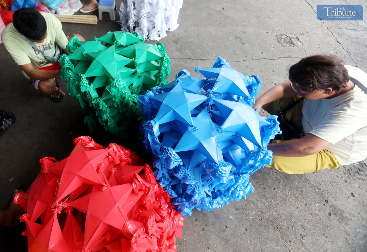With 37 days until Christmas, customers shop for colorful traditional parols at Mega Q Mart in Quezon City on Monday, 18 November 2024.