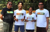 Ayl Gonzaga (second from right) smiles after posting a two-title sweep in the Dipolog City National Juniors Tennis Championships at the RGS and Mibang courts. Also shown are (from left) PPS-NTC tournament referee Karen Arellano, Pete Bandala and Dr. Ian Bandala.