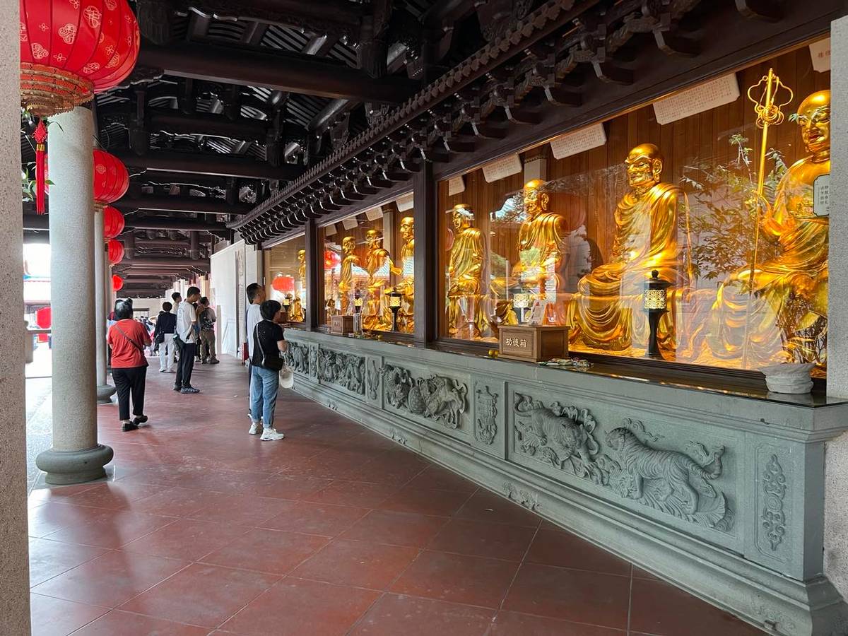 Offered Prayers: Golden deities in a row at the South Putuo Temple.
