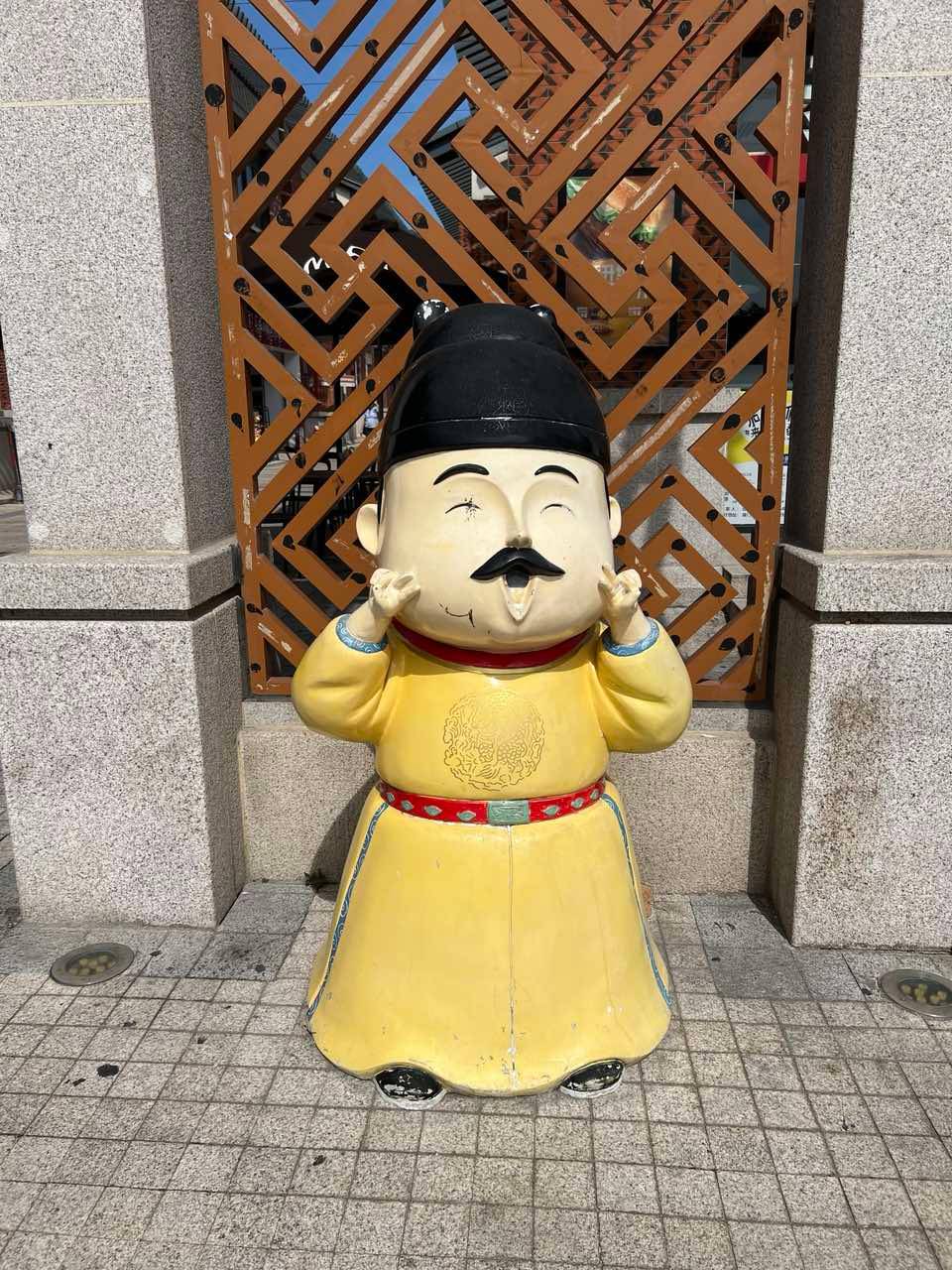 Wear a smile: Official Greeter at the Zengcuoan Village.