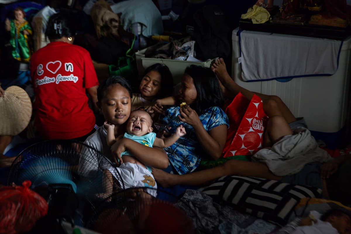 Thousands of families displaced by the Islang Puting Bato fire seek shelter at the Delpan Evacuation Center in Tondo, Manila, on Monday, 25 November.