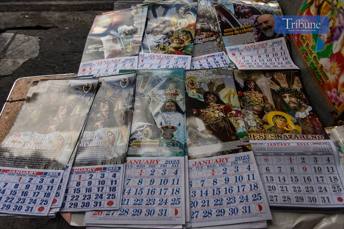 Vendors sell miniature replicas of the Black Nazarene and other devotional items in Quiapo, Manila, on Tuesday, 26 November.