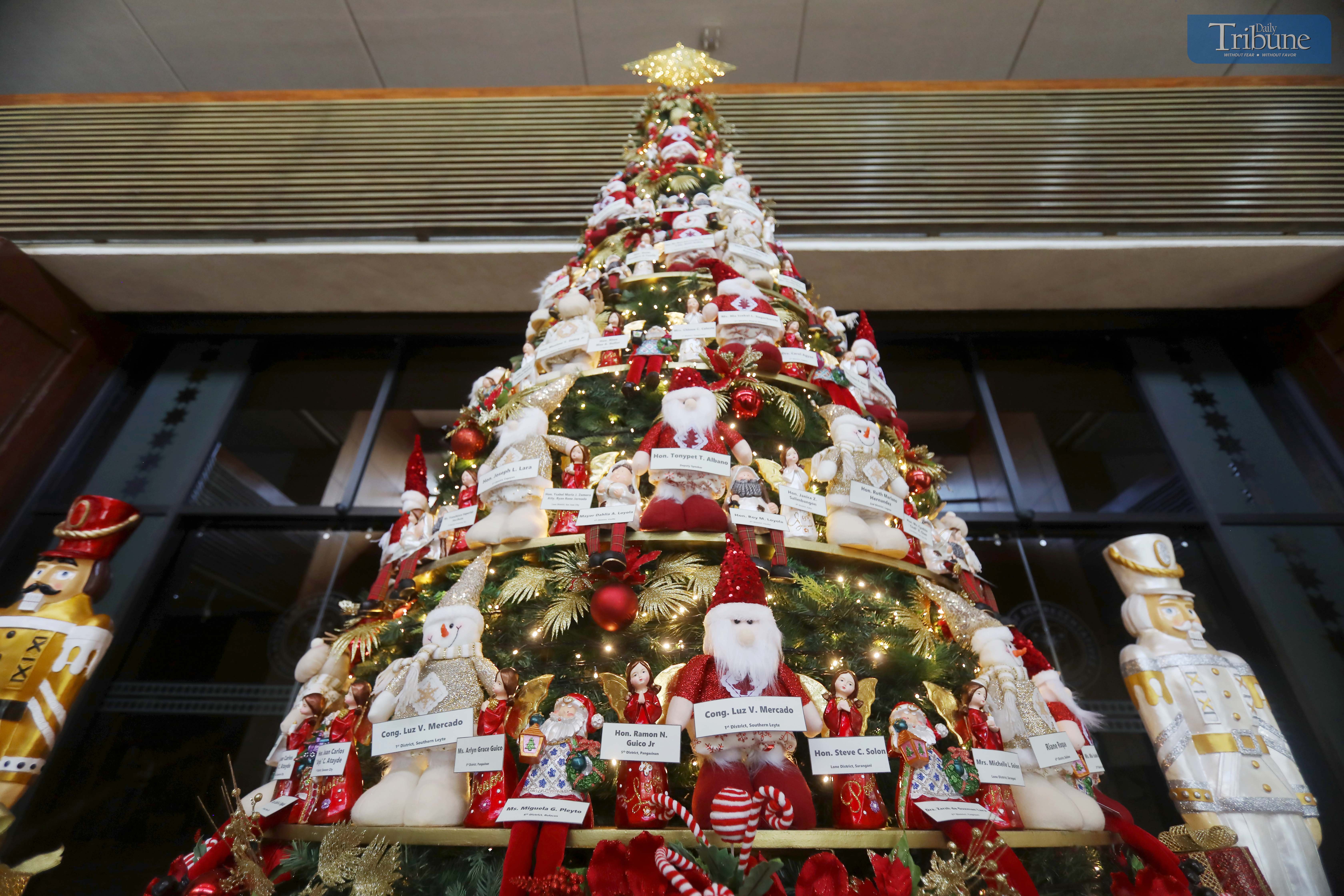 A giant Christmas tree adorned with the names of President Ferdinand "Bongbong" Marcos Jr., First Lady Liza Araneta Marcos, and lawmakers stands at the main entrance of the plenary hall of the House of Representatives.