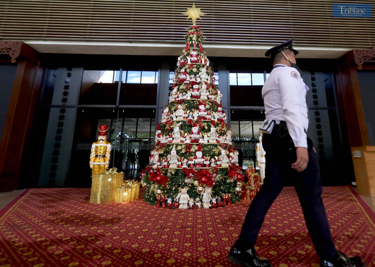 A giant Christmas tree adorned with the names of President Ferdinand "Bongbong" Marcos Jr., First Lady Liza Araneta Marcos, and lawmakers stands at the main entrance of the plenary hall.