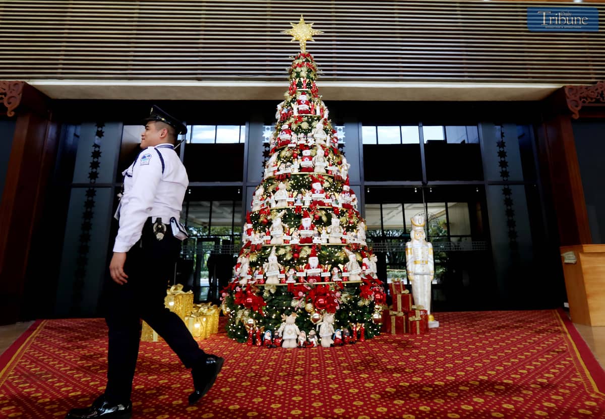 A giant Christmas tree adorned with the names of President Ferdinand "Bongbong" Marcos Jr., First Lady Liza Araneta Marcos, and lawmakers stands at the main entrance of the plenary hall.