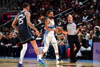 ATLANTA, GA - 25 NOVEMBER: Trae Young #11 of the Atlanta Hawks brings the ball up court during the game against the Dallas Mavericks at State Farm Arena in Atlanta, Georgia.