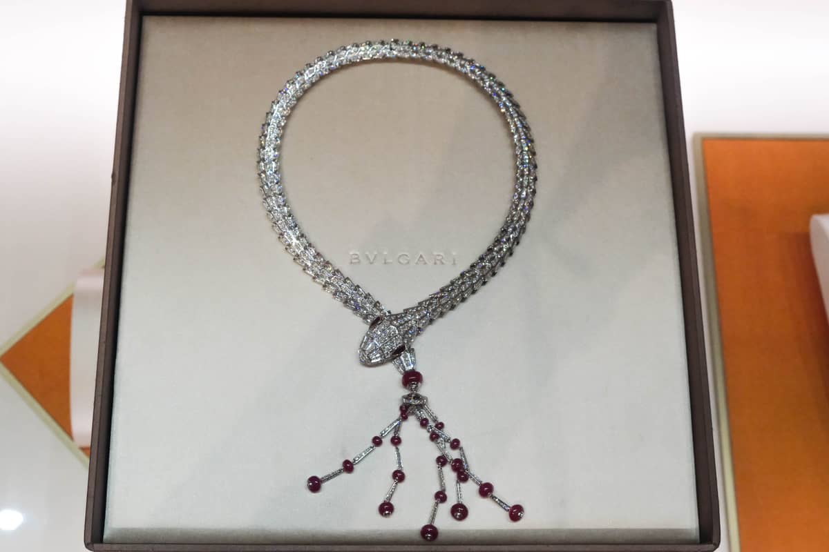 Serpenti High Jewelry Necklace in white gold set with 2 pear brilliant cut rubies (1.07 ct), 21 round bead rubies (41.11 ct) and pavé-set diamonds.