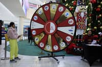 EAST RUTHERFORD, NEW JERSEY - 29 NOVEMBER: A woman take part in a roulette prices game as she visits the American Dream Mall During Black Friday sales in East Rutherford City. Black Friday, is the sales event that is considered the unofficial kickoff of the holiday shopping season and one of the busiest days of the year for retail foot traffic in the U.S.