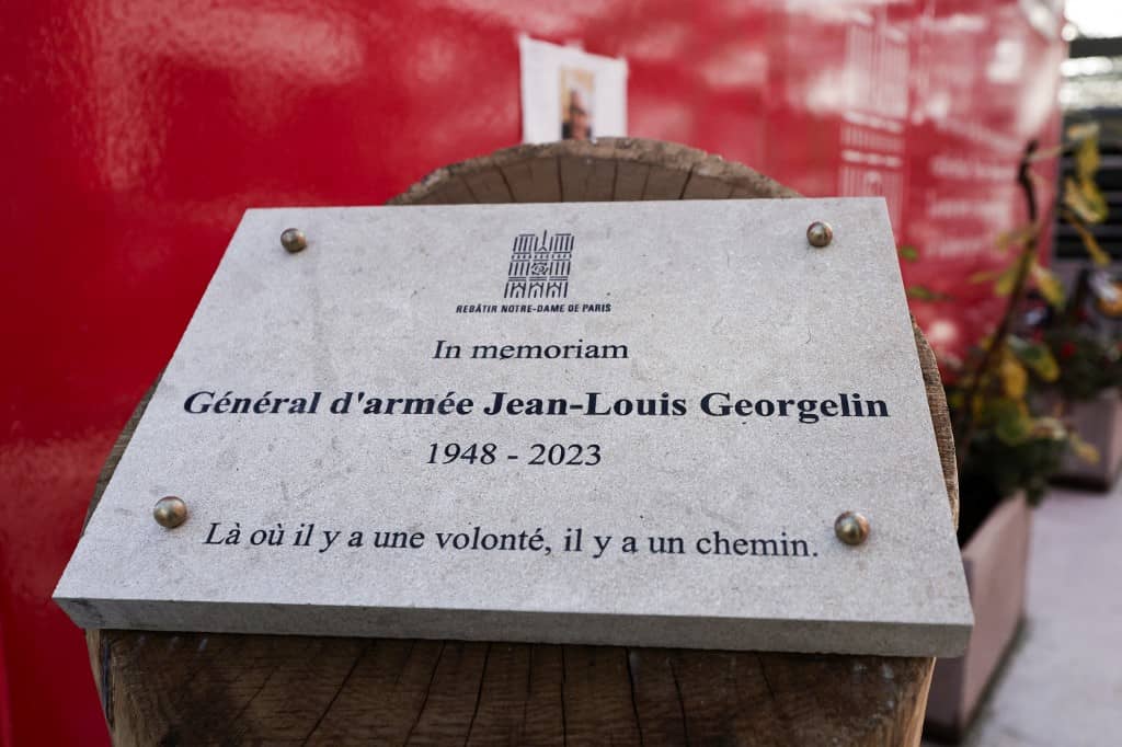 This photograph shows a memorial stele for the former French army chief in charge of restoring Paris's Notre-Dame Cathedral, outside Notre-Dame de Paris cathedral in Paris, on November 29, 2024. The Notre-Dame Cathedral is set to re-open early December 2024, with a planned weekend of ceremonies on December 7 and 8, 2024, five years after the 2019 fire which ravaged the world heritage landmark and toppled its spire. Some 250 companies and hundreds of experts were mobilised for the five-year restoration costing hundreds of millions of euros.