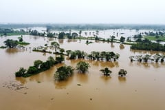 Malaysia floods displace 122,000, India cyclone shuts schools