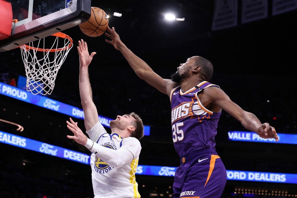 PHOENIX, ARIZONA - NOVEMBER 30: Kevin Durant #35 of the Phoenix Suns blocks a layup attempt by Pat Spencer #61 of the Golden State Warriors during the second half at Footprint Center in Phoenix, Arizona.