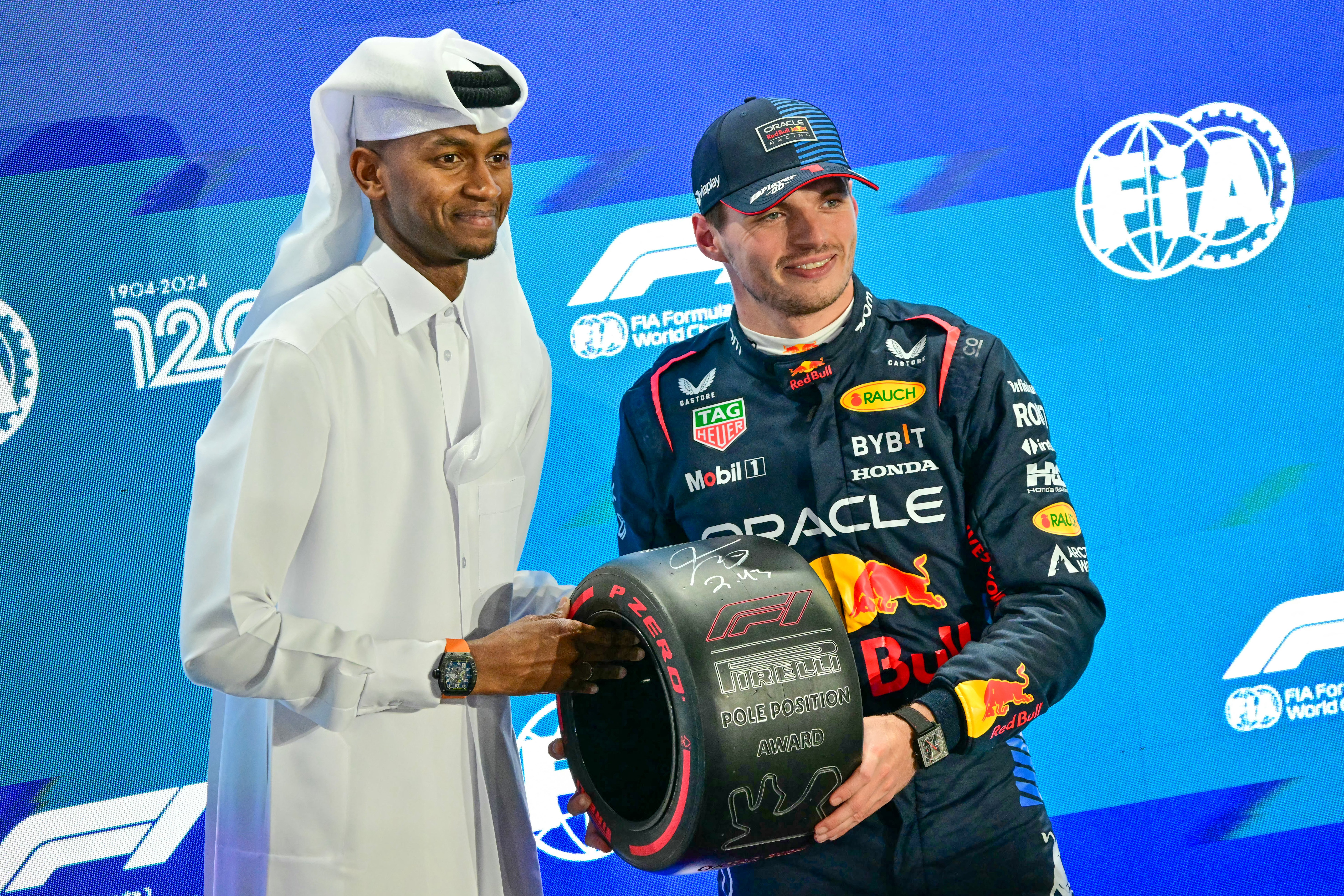 Red Bull Racing’s Max Verstappen (right) receives the pole position trophy from Qatar’s track and field athlete Mutaz Essa Barshim at the end of the qualifying session of the Qatari Formula One Grand Prix at the Lusail International Circuit in Lusail, Qatar.