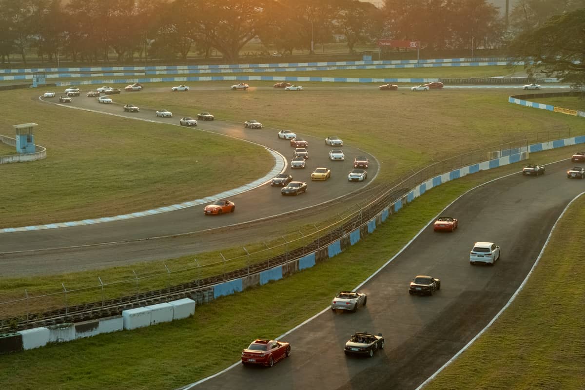 All in A perfect end to a great day. A sunset parade of Mazdas at the track.