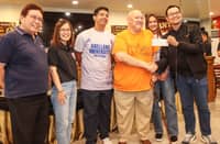 Arellano University executive Peter Cayco (second from right) receives the check worth P1,759,358 from Shakey’s Pizza Ventures Inc. general manager Oliver Sicam (right) as donation to the school’s women’s volleyball program during the turnover event at Shakey’s Malate.