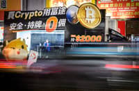 Bitcoin exchange advertisement truck in Hong Kong passes by as the cryptocurrency burst past $100,000 for the first time on 4 December as traders welcomed Donald Trump’s pick to head the US securities commission.