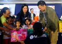 USAID hands over the educational materials to DepEd Secretary Juan Edgardo Angara (right) at Bula Central School in Camarines Sur on 2 December.