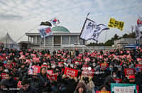 LOOK: People take part in a protest calling for the ouster of South Korea President Yoon Suk Yeol outside the National Assembly in Seoul on 7 December 2024. South Korea's embattled President Yoon Suk Yeol apologised but stopped short of resigning on December 7 over his declaration of martial law, as protesters gathered outside parliament ahead of a crucial impeachment vote that could decide his political fate.