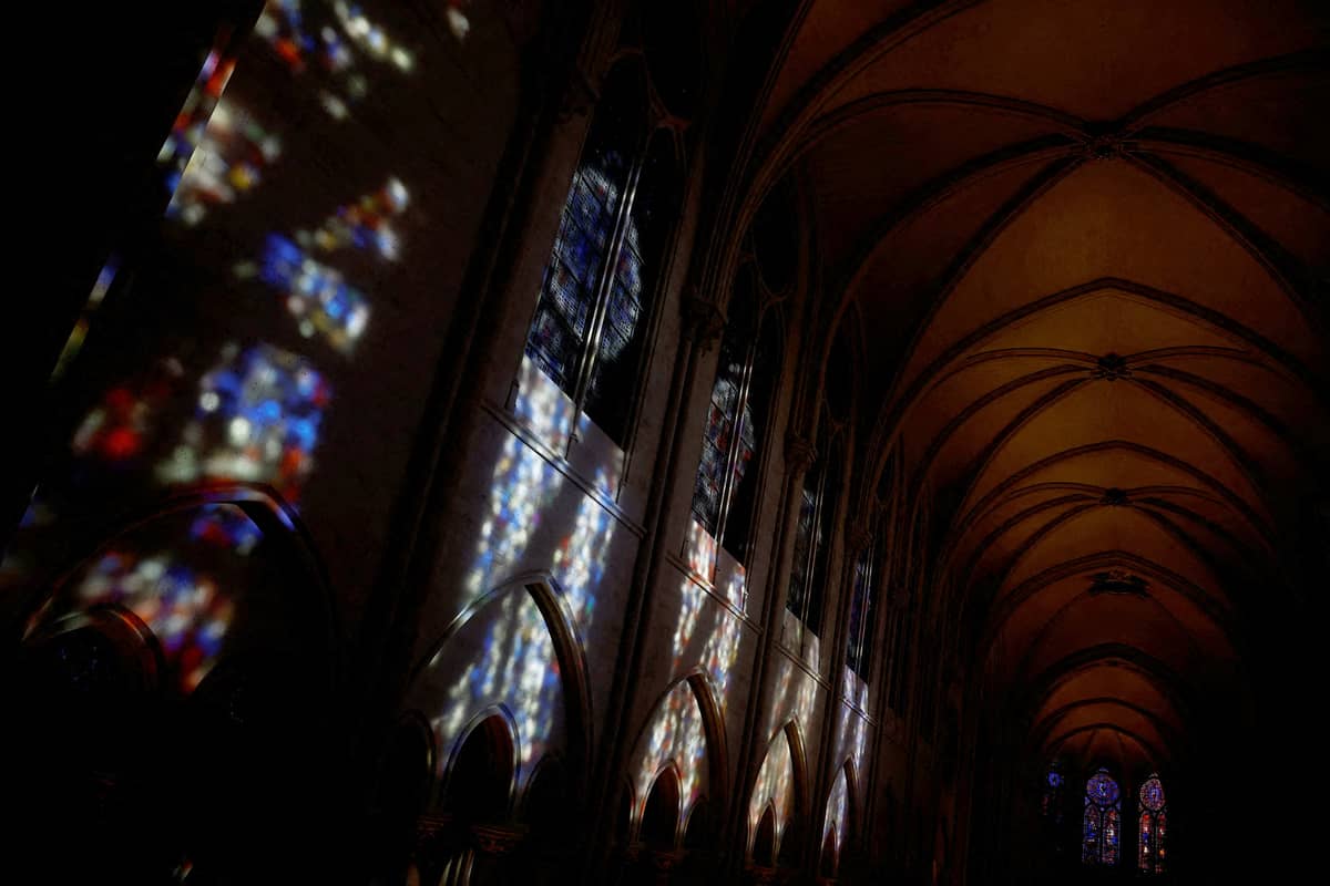 This photograph shows the light reflected from stained glass windows on a wall in the Notre-Dame de Paris Cathedral in Paris, on 29 November 2024.