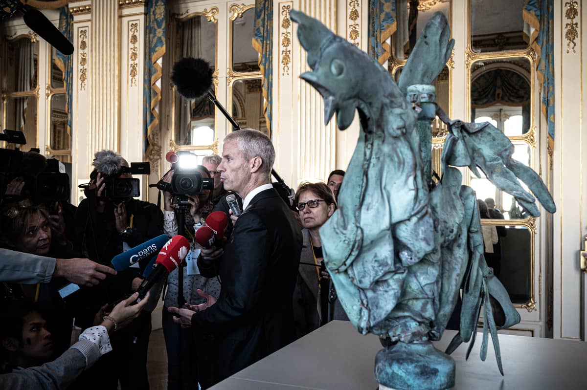 French Culture Minister Franck Riester addresses the media as he stands next to the rooster which sat atop of the spire of the Notre-Dame cathedral, during a presentation of the exhibition "Revoir Notre-Dame de Paris" (To see again Notre-Dame de Paris) at the Culture Ministry in Paris, on 20 September 2019 as part of the heritage days.