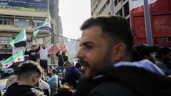 Syrian and Lebanese people celebrate the fall of the Syrian regime on 8 December, 2024, in the northern Lebanese city of Tripoli, after the Syrian capital Damascus fell into the hands of anti-government fighters. Islamist-led rebels declared that they have taken Damascus in a lightning offensive on December 8, sending President Bashar al-Assad fleeing and ending five decades of Baath rule in Syria.