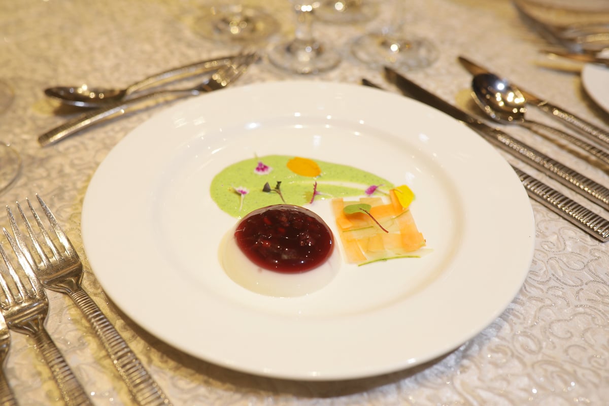 Waldorf Aspic, a creative take on the classic Waldorf salad, presented in a clear jelly with assorted organic salad greens and microgreens.