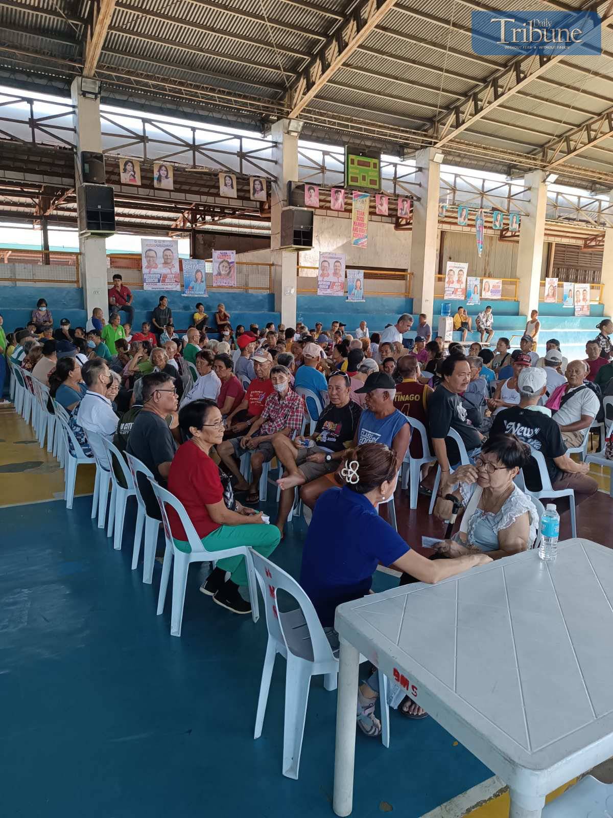 Centenarians and families waiting for cash gifts.