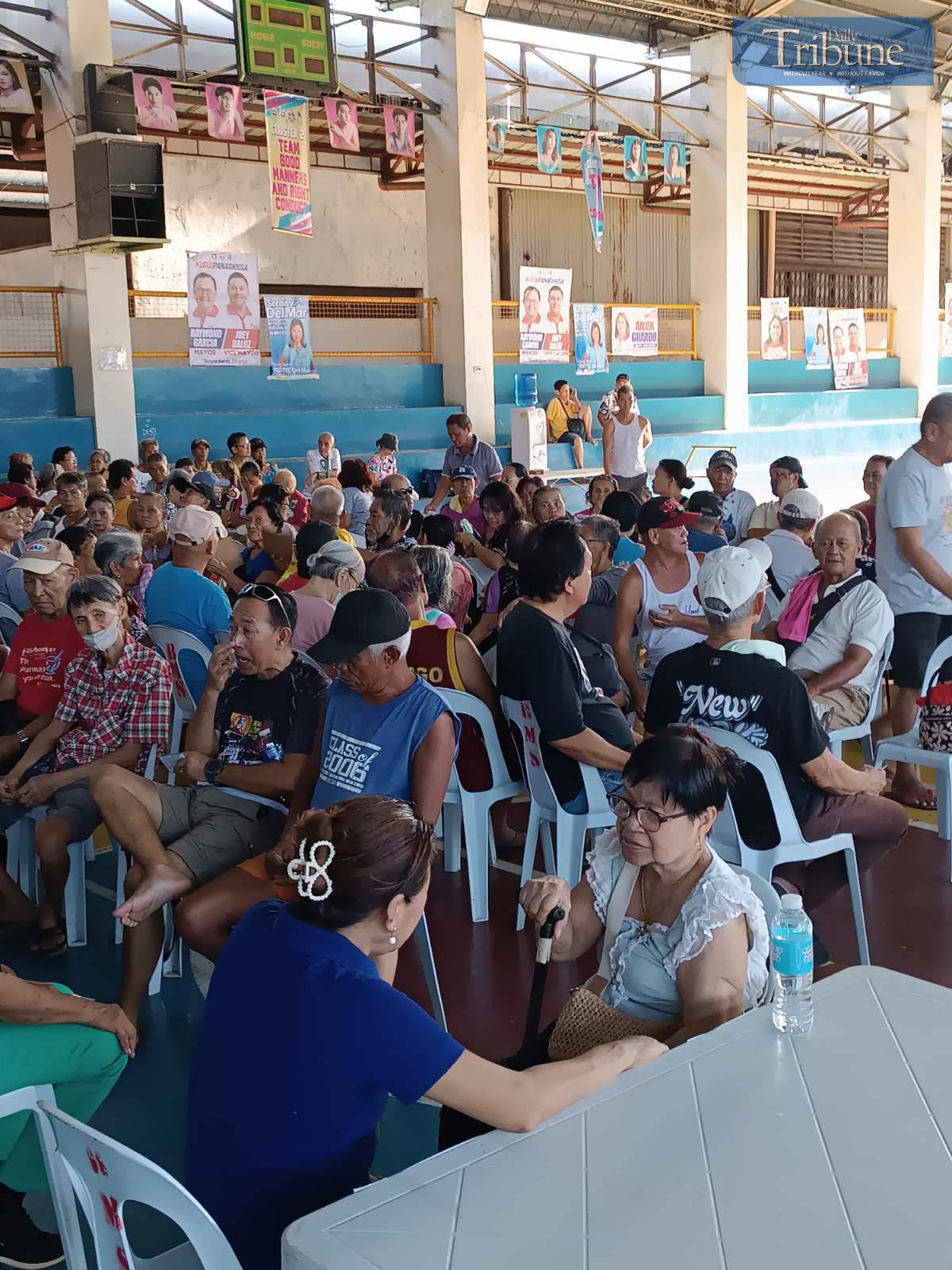Centenarians and families waiting for cash gifts.