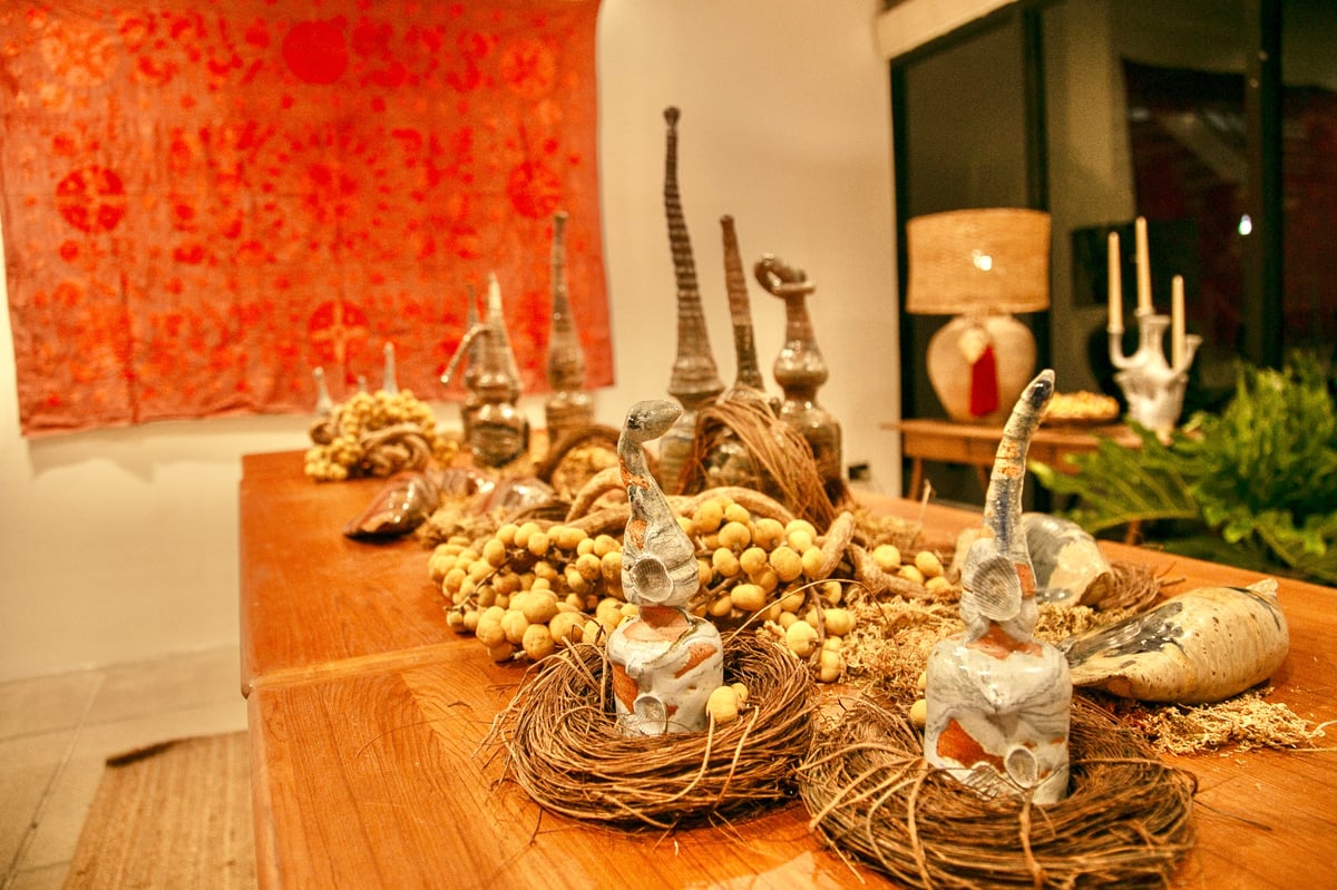 Solon Perfecto’s sculptures have tall, pointy hats, volatile glaze movements on the body, and slip brushstrokes that portray the nature and rural surroundings of his studio.