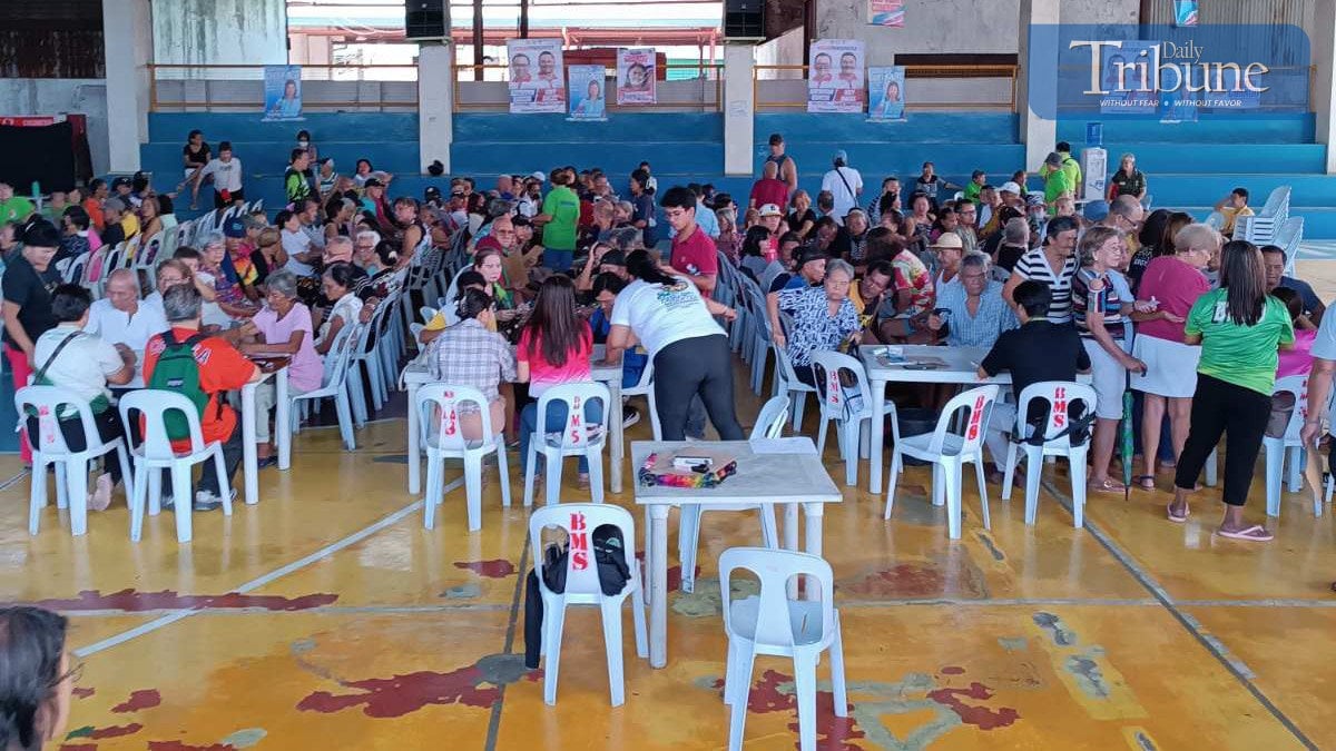 Centenarians and families waiting for cash gifts.