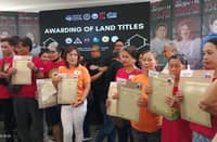385 families receive land titles