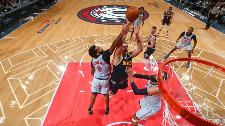 WASHINGTON, DC - 7 DECEMBER: Nikola Jokic #15 of the Denver Nuggets drives to the basket during the game against the Washington Wizards at Capital One Arena in Washington, DC.