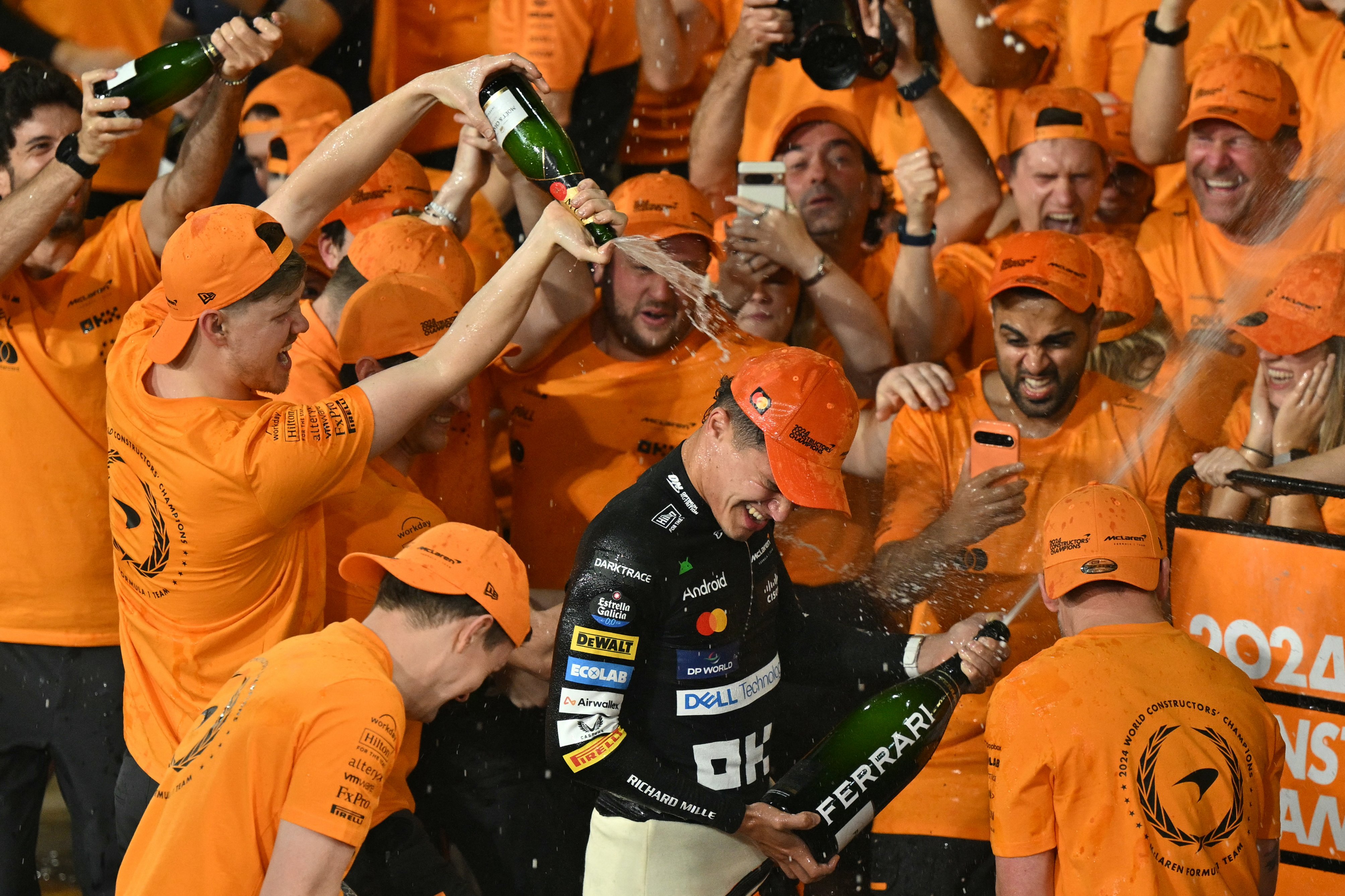 LANDO Norris gets a victory shower after helping McLaren win its first team title in 26 years following a victorious performance in the Abu Dhabi Grand Prix.