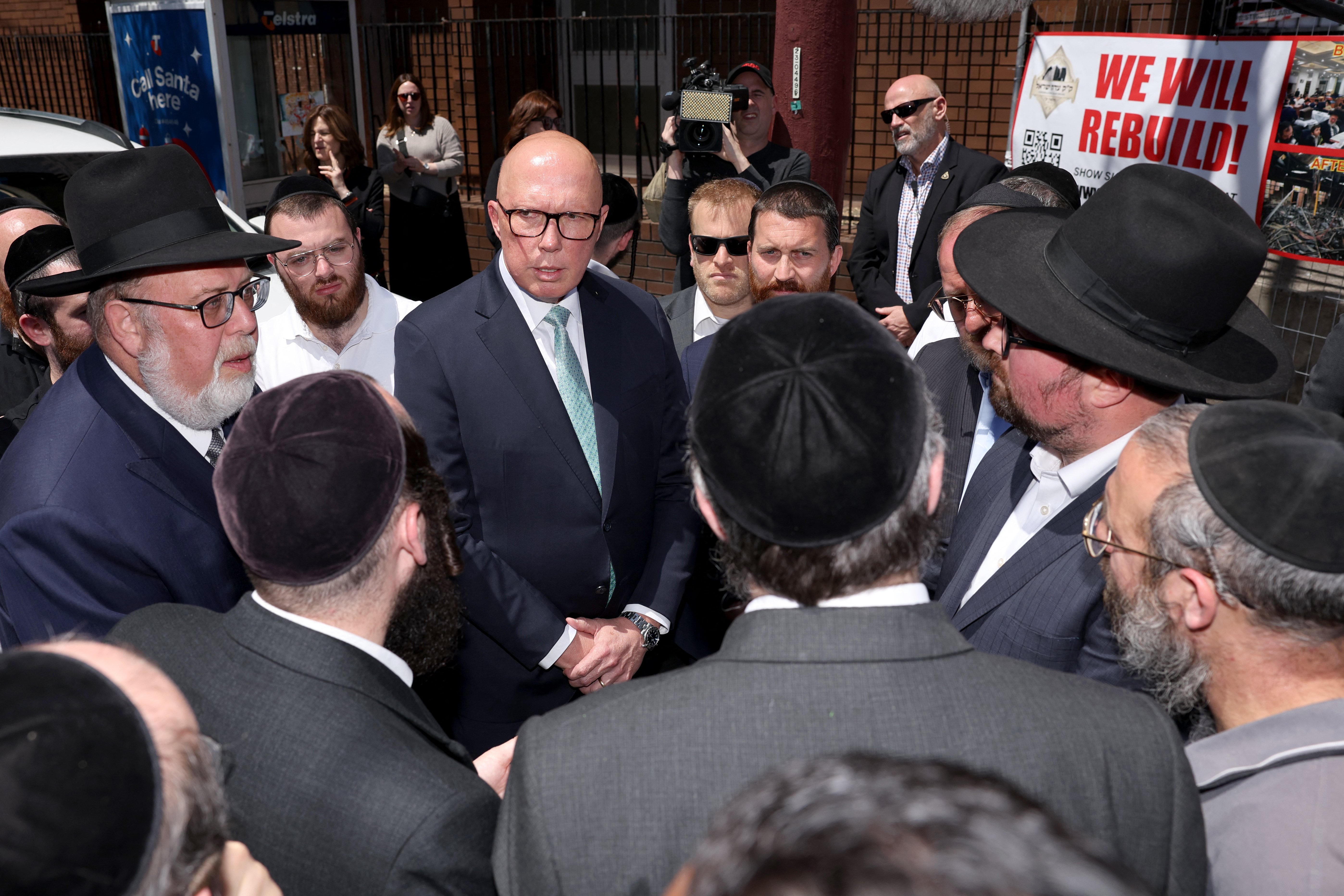 AUSTRALIA’s opposition leader Peter Dutton (center) speaks to members of the Jewish community outside the damaged Adass Israel Synagogue in the Melbourne suburb of Ripponlea on 9 December 2024. Australian police said on 9 December they are hunting for three suspects linked to a Melbourne synagogue blaze, which authorities have designated as a terrorist