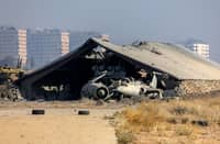 This picture shows a burned Syrian army helicopter after Israeli strikes said to target weapons depots near the Mezzeh military airbase, outside Damascus, on December 9, 2024.