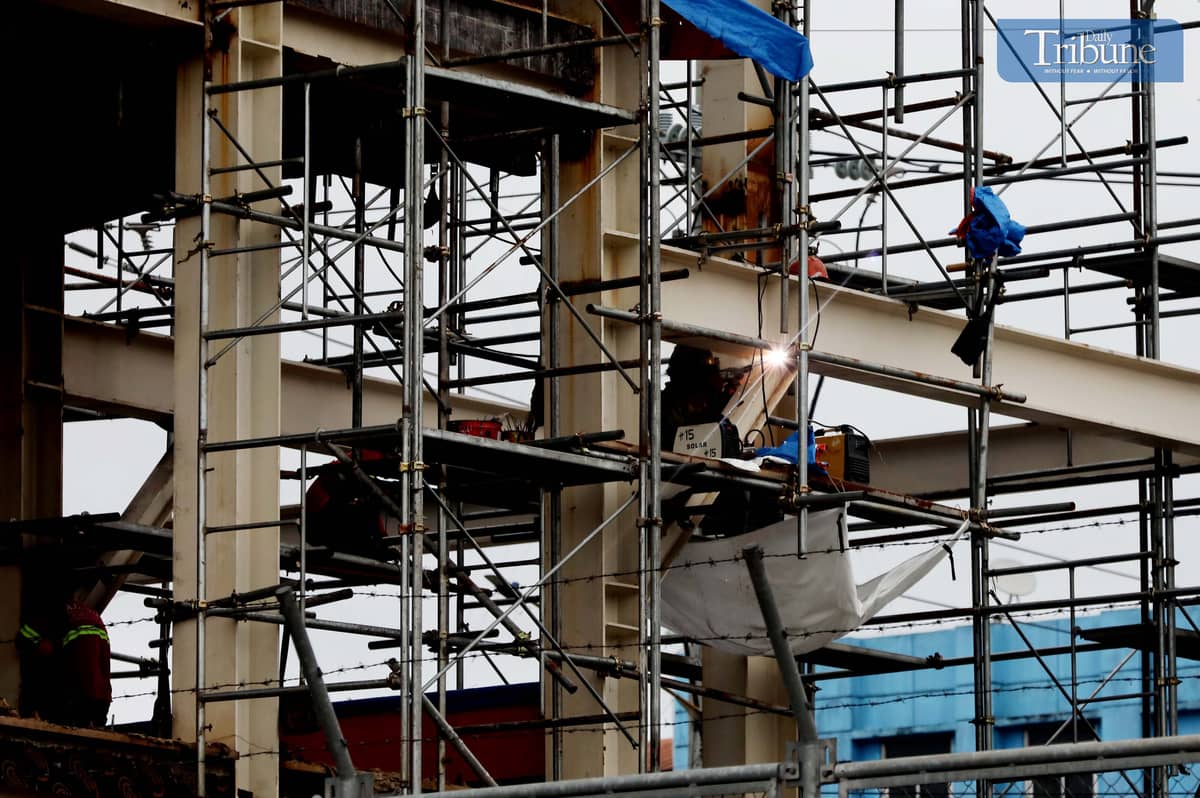Workers weld metal for the MRT7 construction along Commonwealth Avenue in Quezon City.