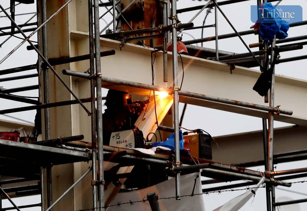 Workers weld metal for the MRT7 construction along Commonwealth Avenue in Quezon City.