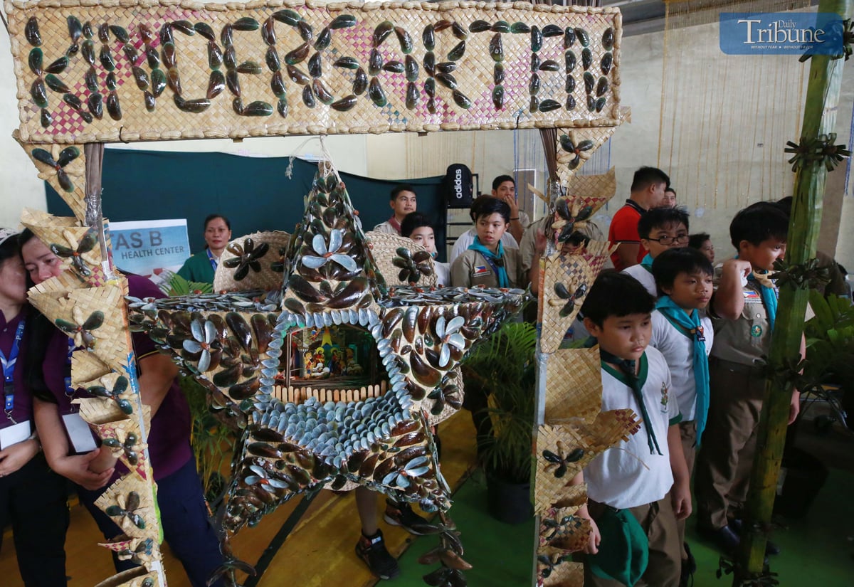 Teachers and students at Payatas B Elementary School in Quezon City craft parols from recycled materials for their eco-friendly Christmas celebration on Tuesday, 10 December 2024.