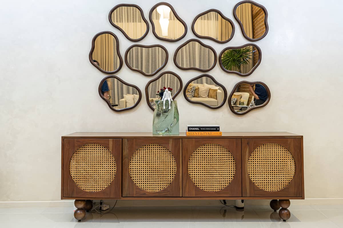 Wall mirror and rattan cabinet.