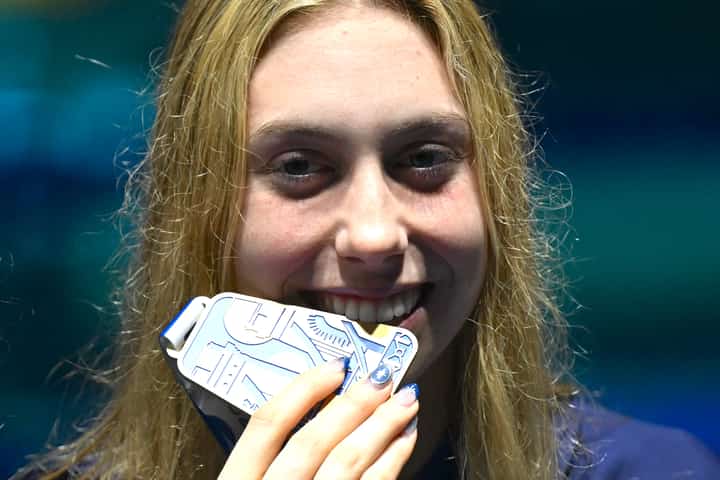 Gretchen Walsh smiles with her gold medal during the short-course World Aquatics Championships at Duna Arena in Budapest.