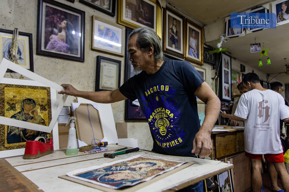 Staff at a Quiapo frame shop work on frames ahead of the holiday rush.