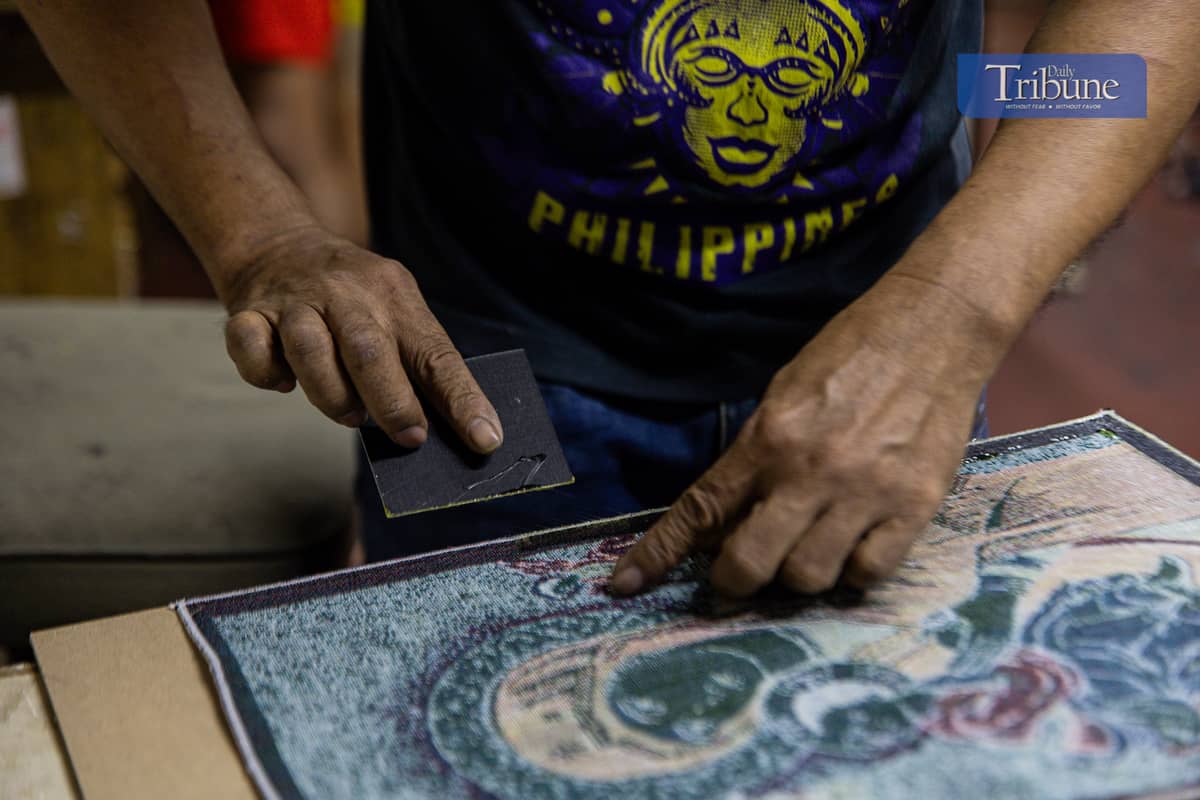 Staff at a Quiapo frame shop work on frames ahead of the holiday rush.