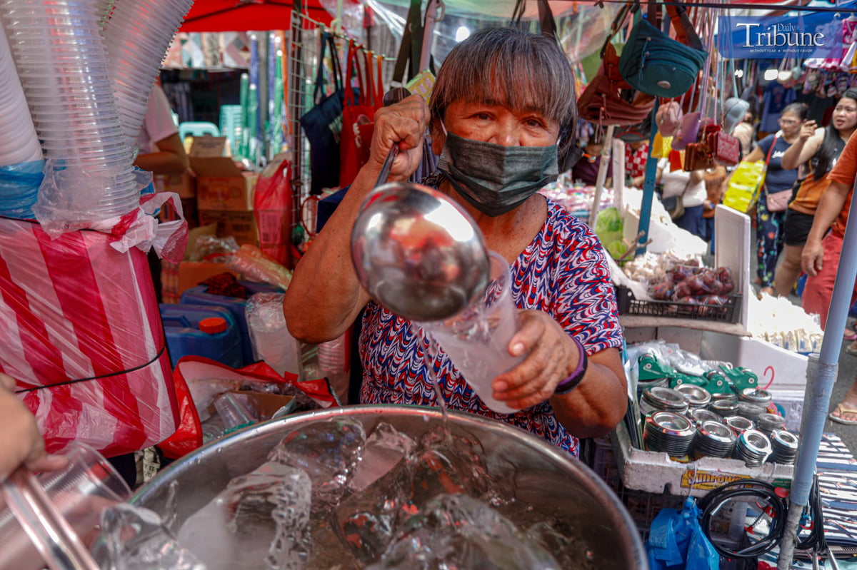 Aling Bebe serves her viral “Magic Water,” a refreshing clear gulaman drink, to quench the thirst of shoppers along Juan Luna Street in Divisoria, Manila.