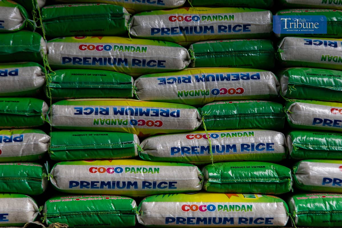 Workers load and unload sacks of rice along Dagupan Street in Divisoria, Manila, on Wednesday, 18 December 2024.